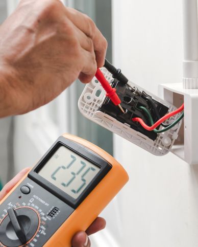 emergency electrician testing a socket